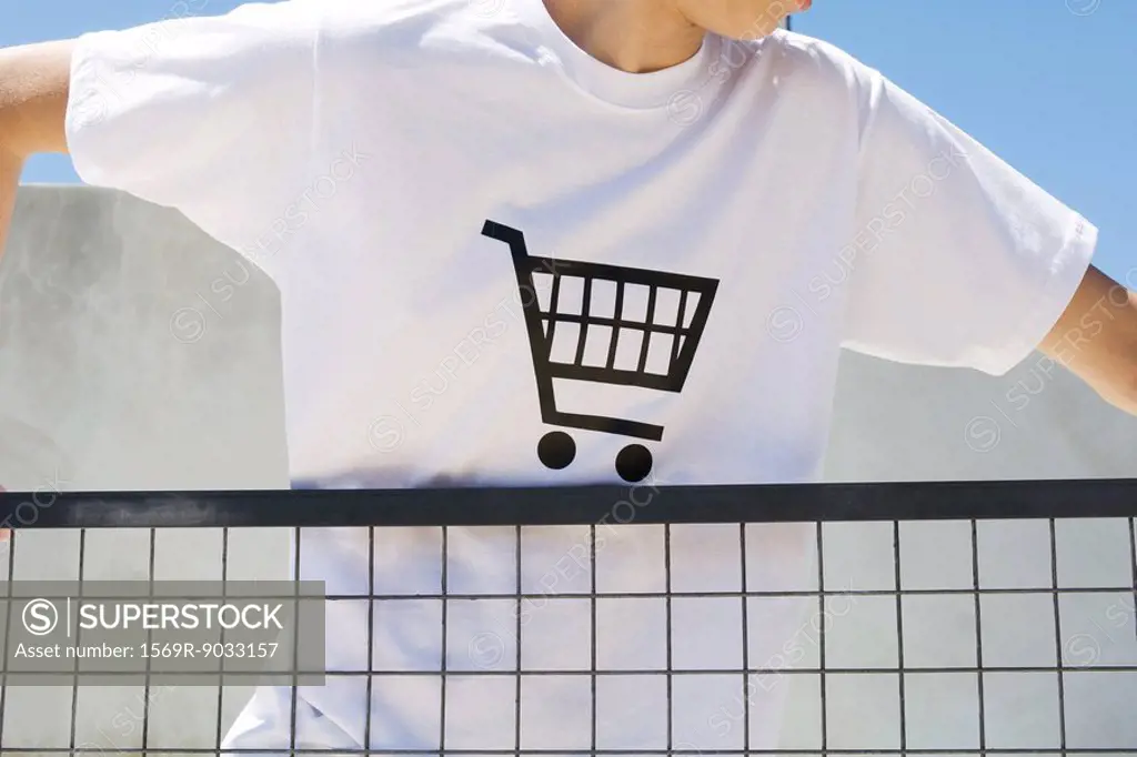 Teenage boy wearing tee-shirt printed with shopping cart, cropped view