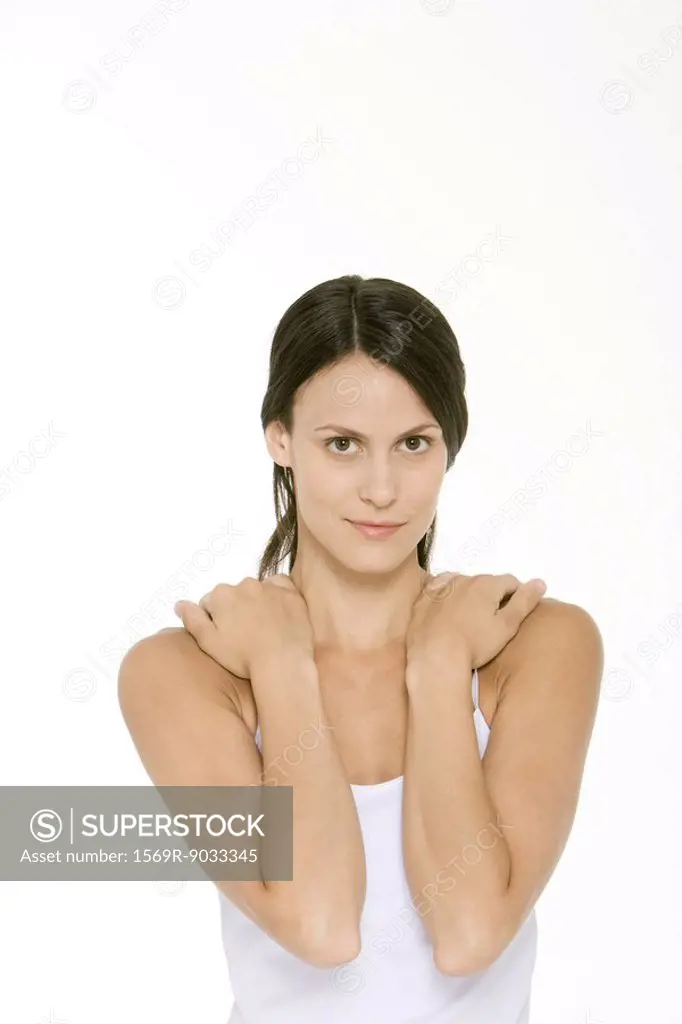 Woman with hands on shoulders, looking at camera