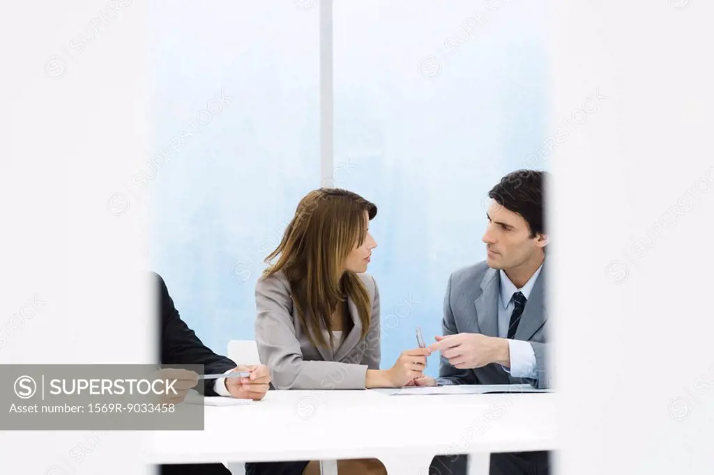Male and female business colleagues talking during meeting