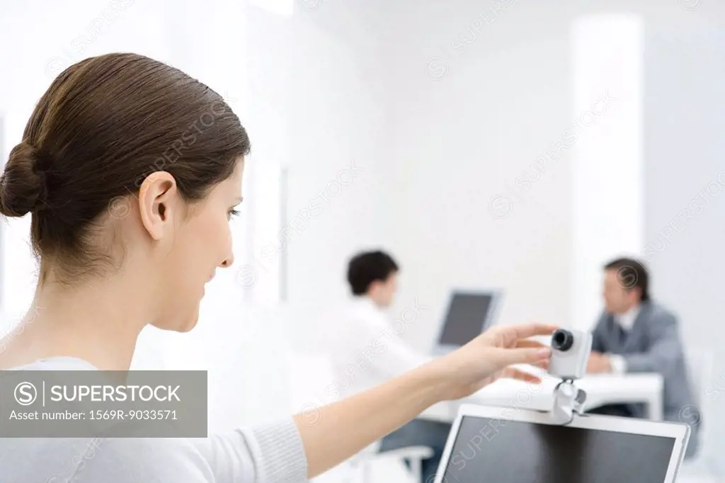 Businesswoman using webcam in office