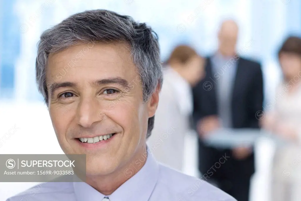 Businessman, smiling at camera, portrait