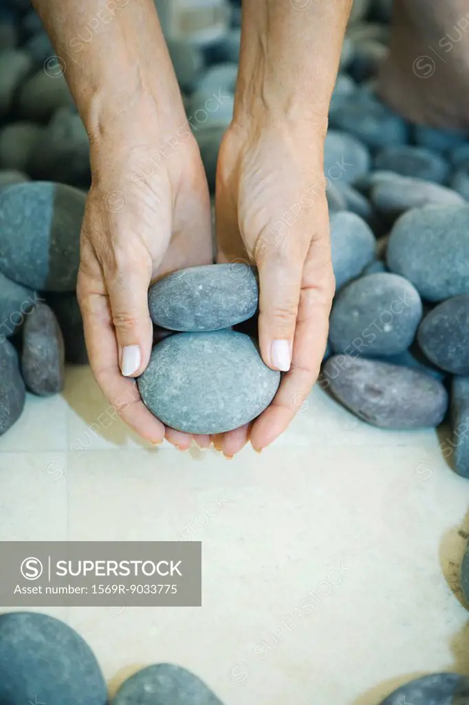 Hands holding pebbles, close-up