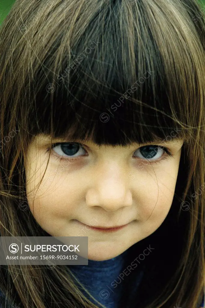 Little girl with bangs smiling, portrait
