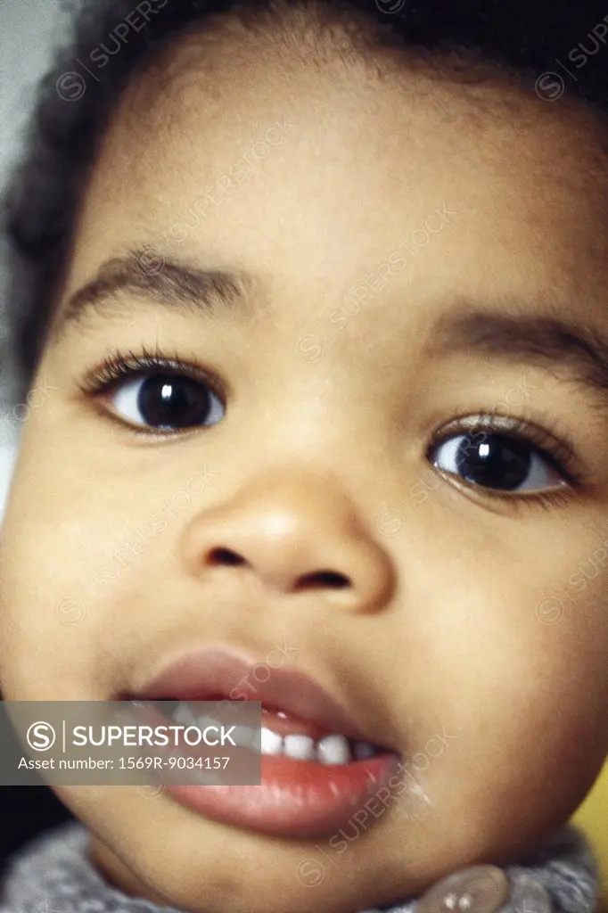 Toddler boy smiling at camera, close-up, portrait