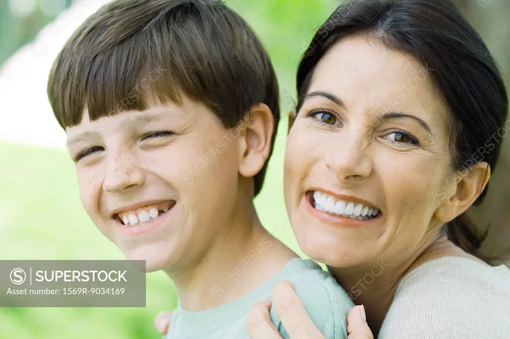 Mother and son smiling at camera, portrait