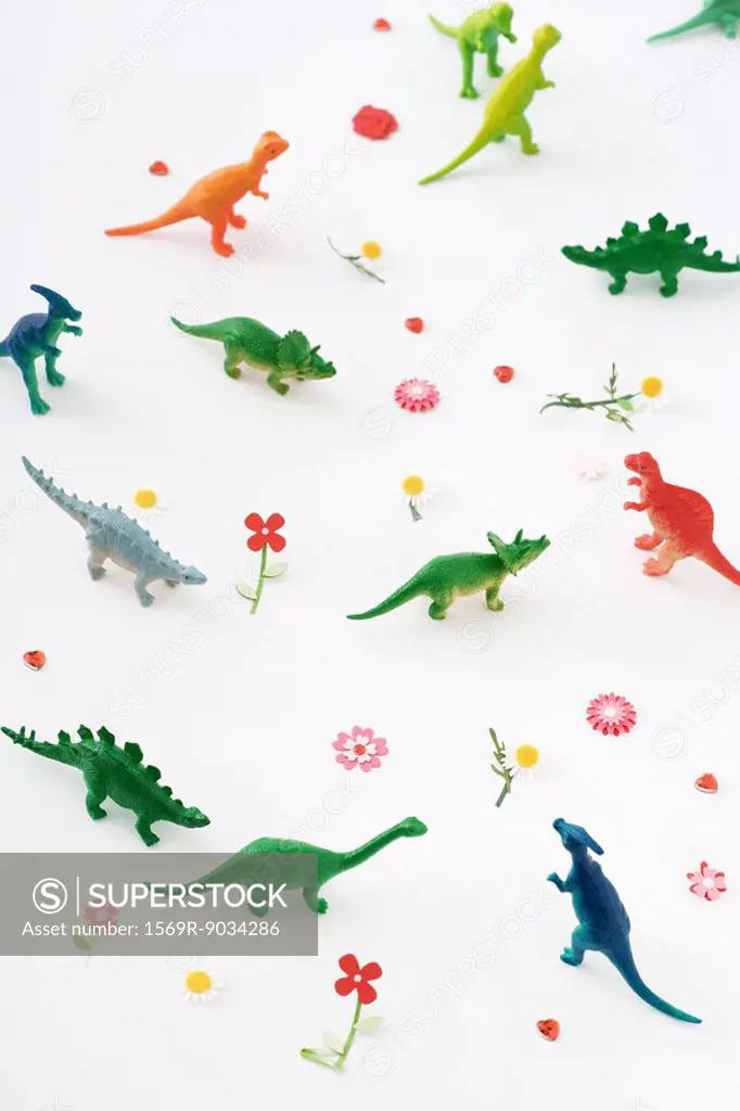 Plastic dinosaurs surrounded by fake flowers, high angle view