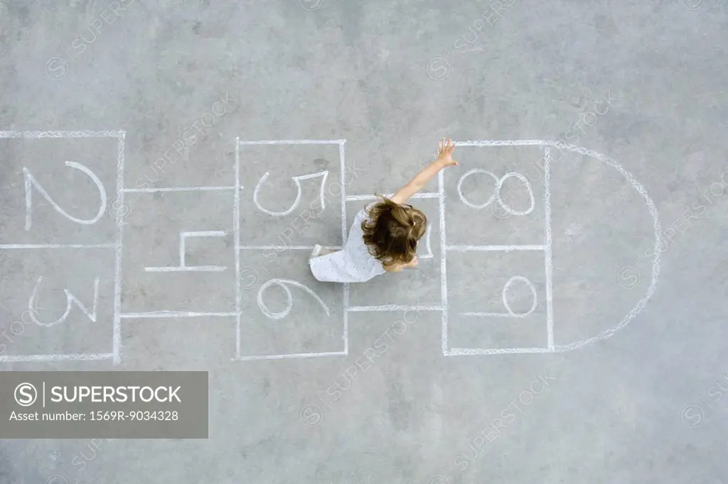 Little girl playing hopscotch, overhead view