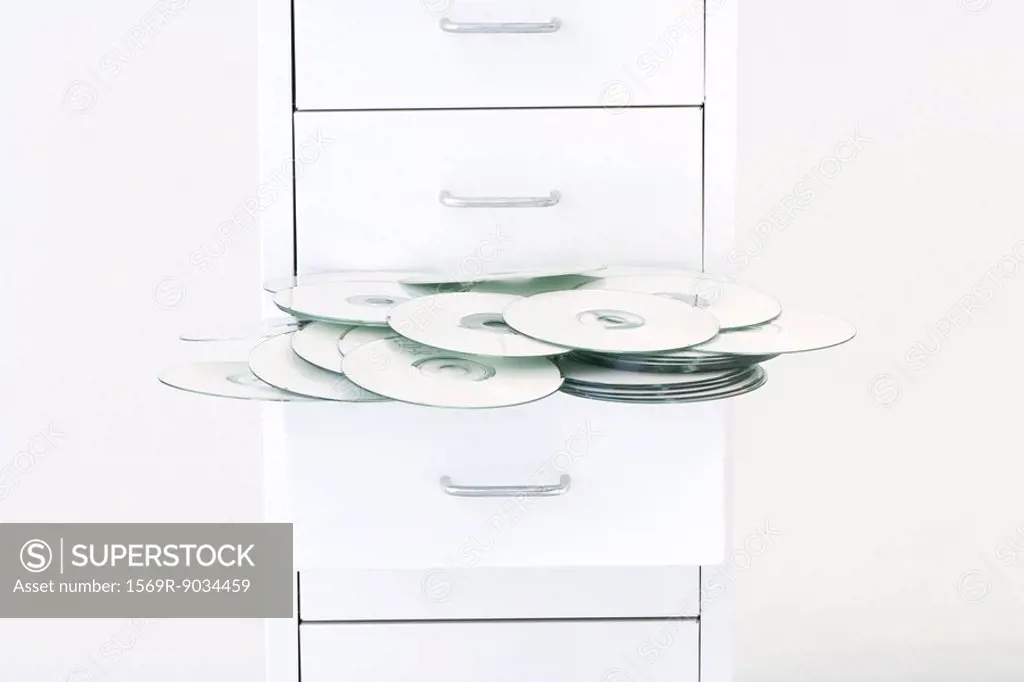 CDs spilling out of filing cabinet drawer