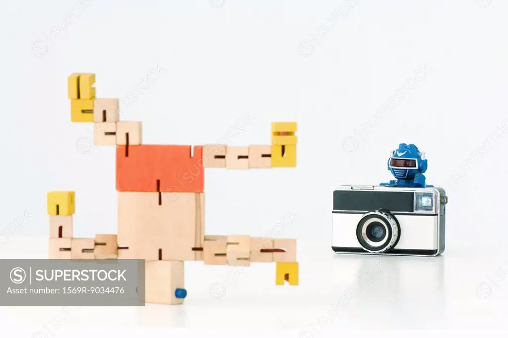 Robot taking photo of second robot breakdancing