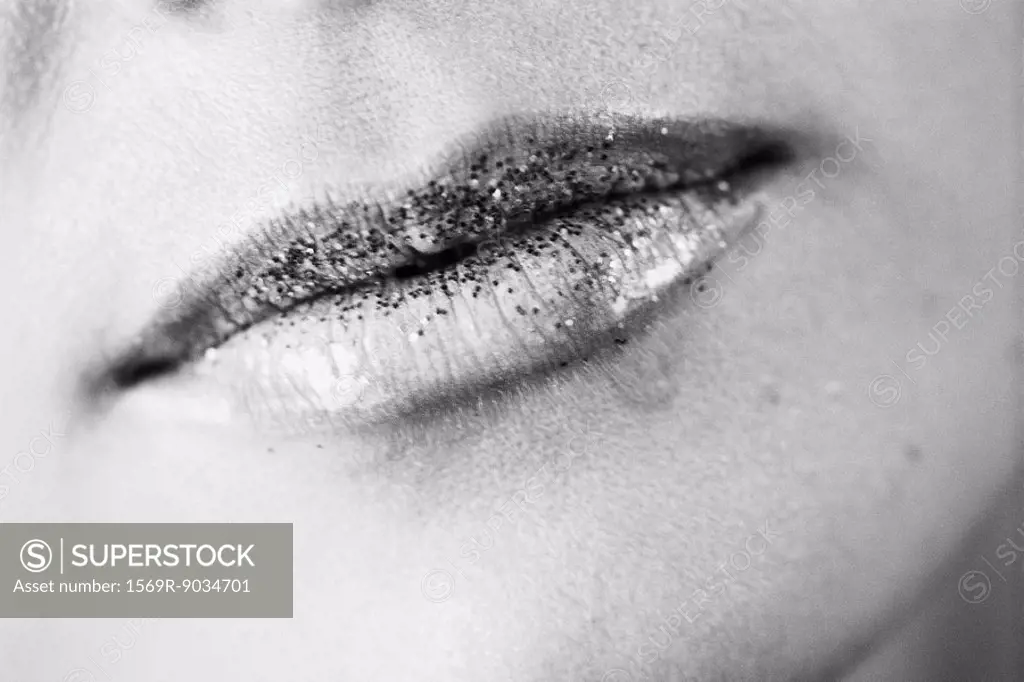 Glitter on woman´s lips, close-up, black and white