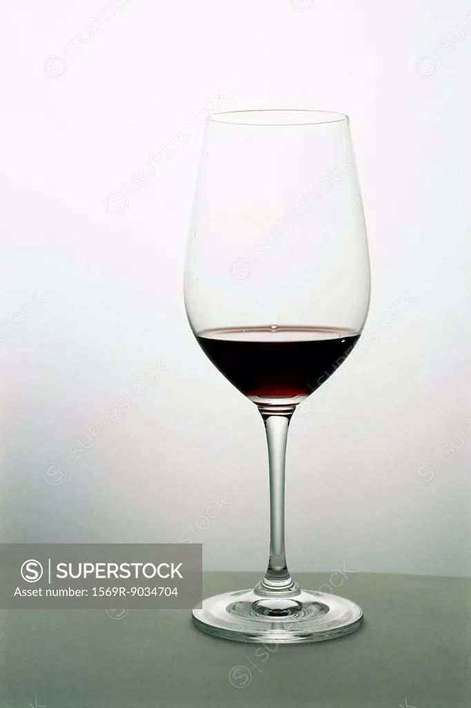 Small amount of red wine in wineglass