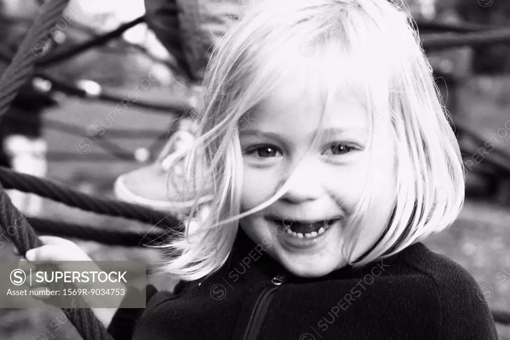 Little girl, smiling at camera, portrait, black and white