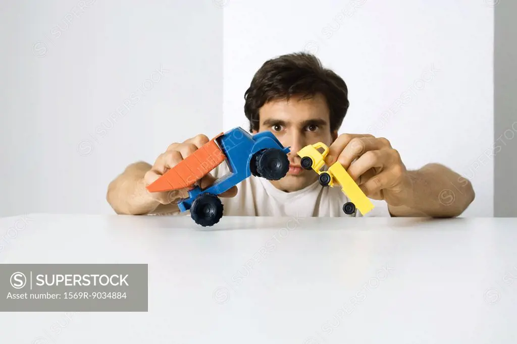 Man playing with toy trucks