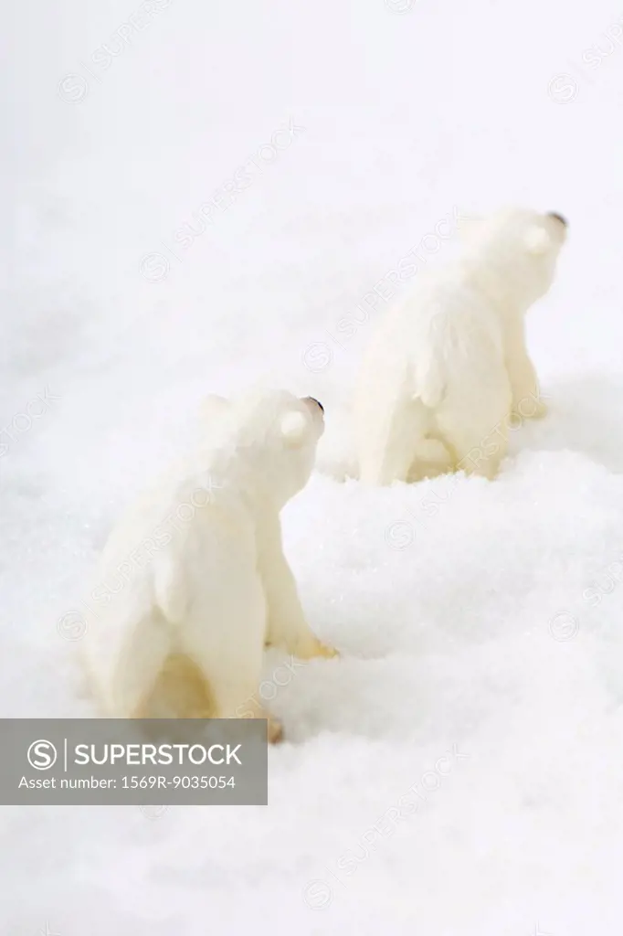 Toy polar bears in snow, rear view
