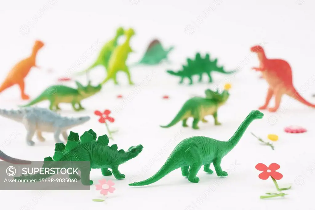 Plastic dinosaurs surrounded by fake flowers