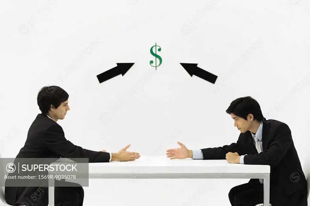 Two businessmen face to face, reaching to shake hands, dollar sign and arrows between them