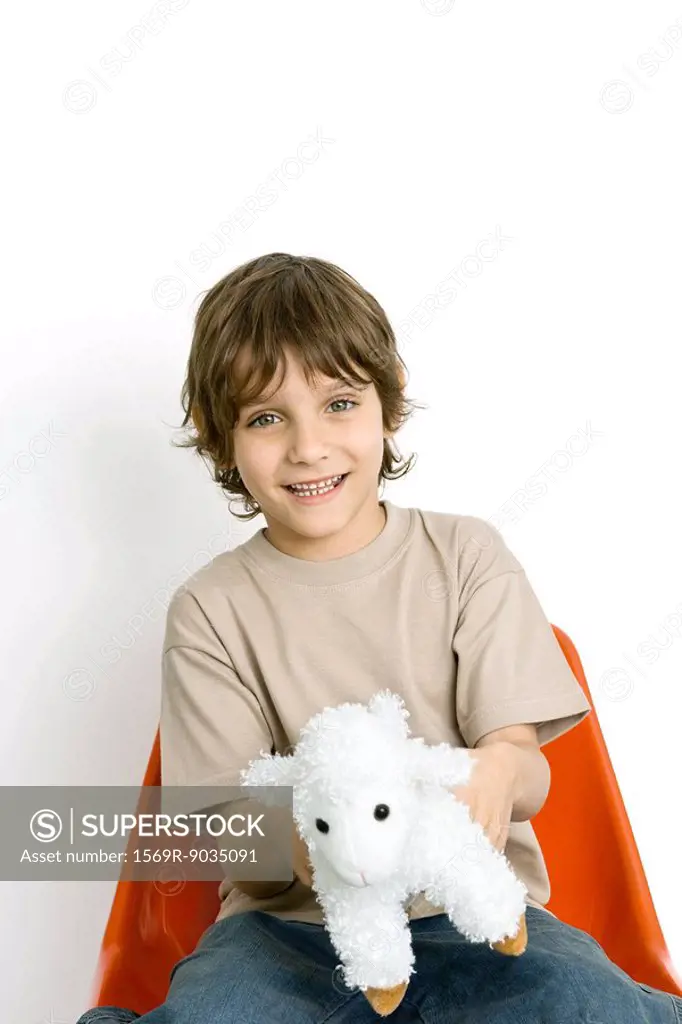 Boy holding plush toy lamb