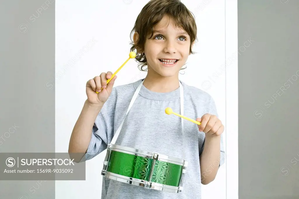 Boy playing toy drum