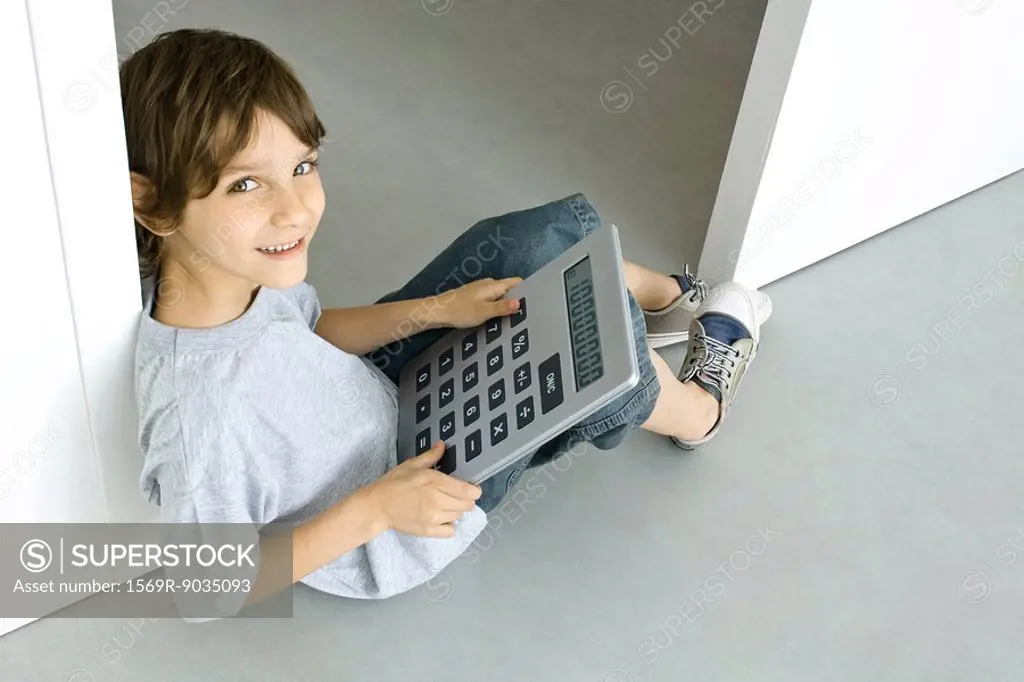 Boy using oversized calculator