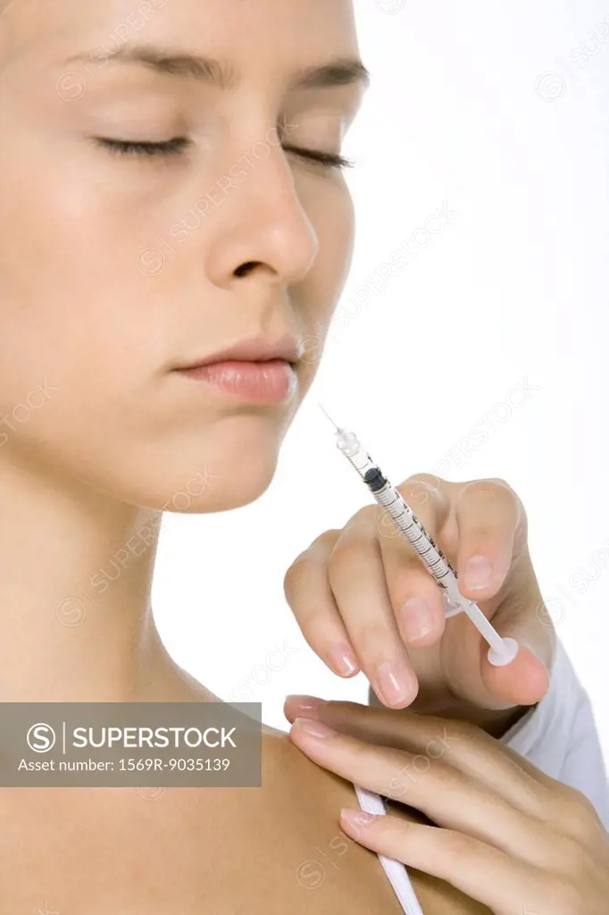 Woman receiving botox injection, eyes closed, close-up
