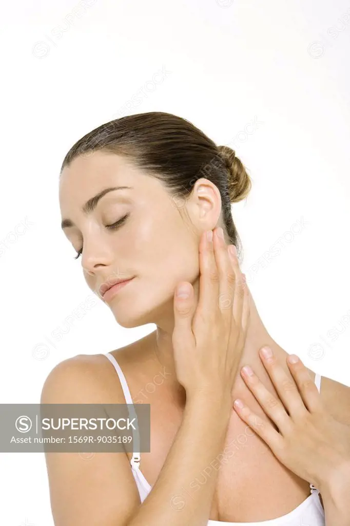 Woman touching neck, eyes closed