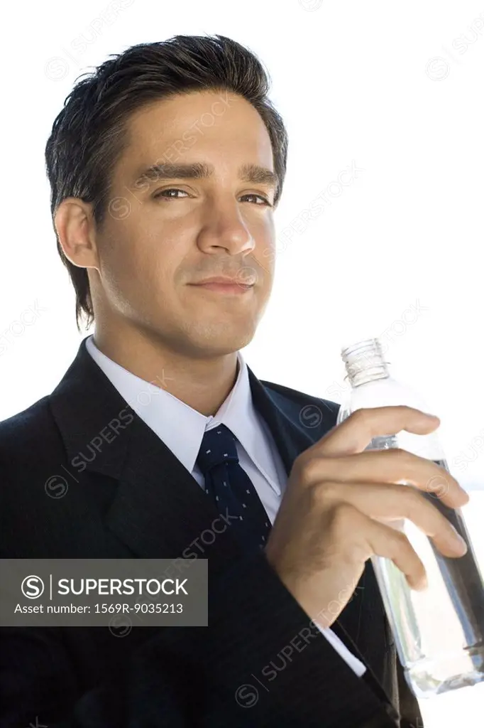 Businessman holding water bottle, looking at the camera, portrait