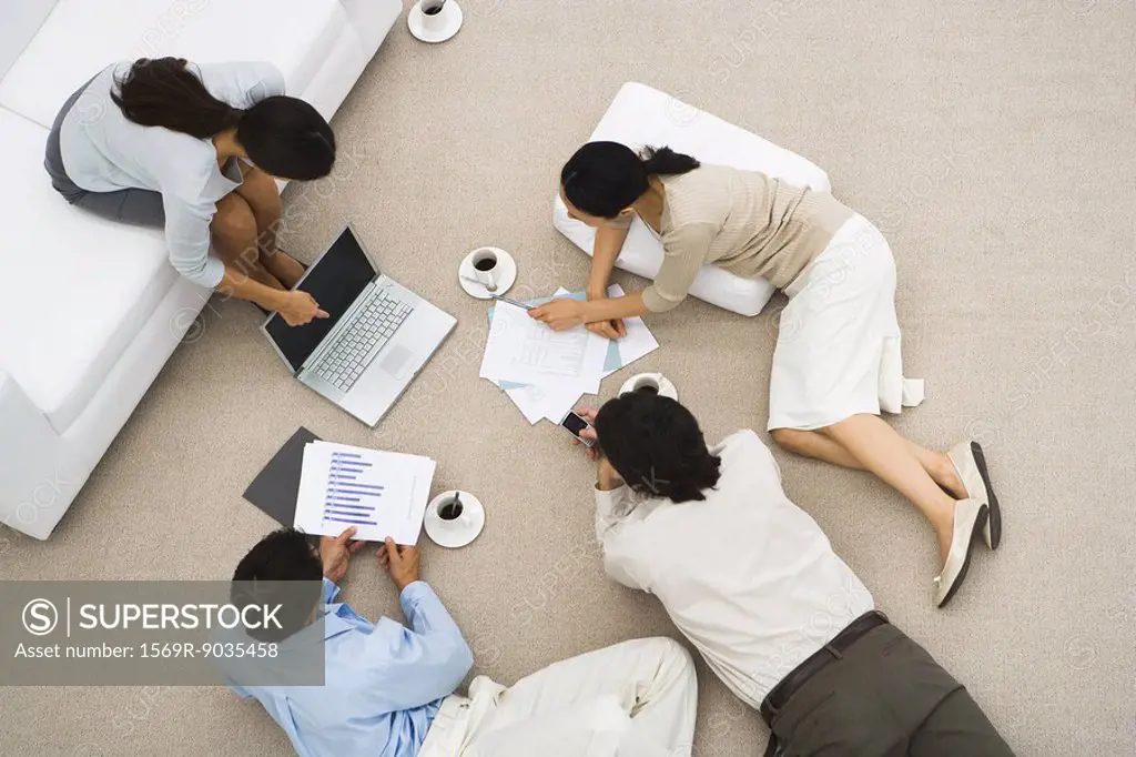 Business meeting, people reclining on the floor, high angle view