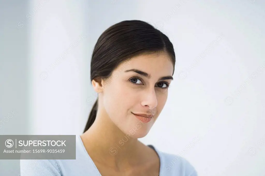 Young woman smiling at camera, portrait