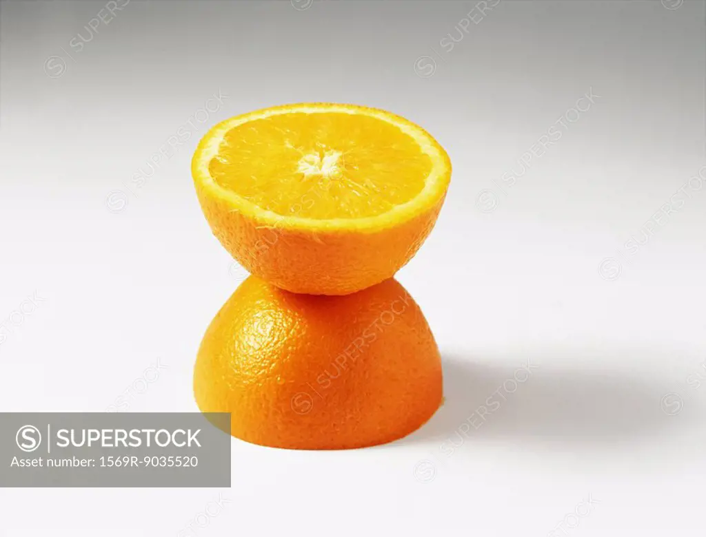 Orange halves, one stacked on top of the other