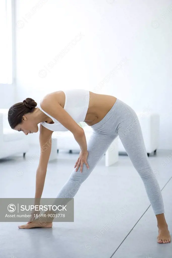 Woman bending over, touching toes