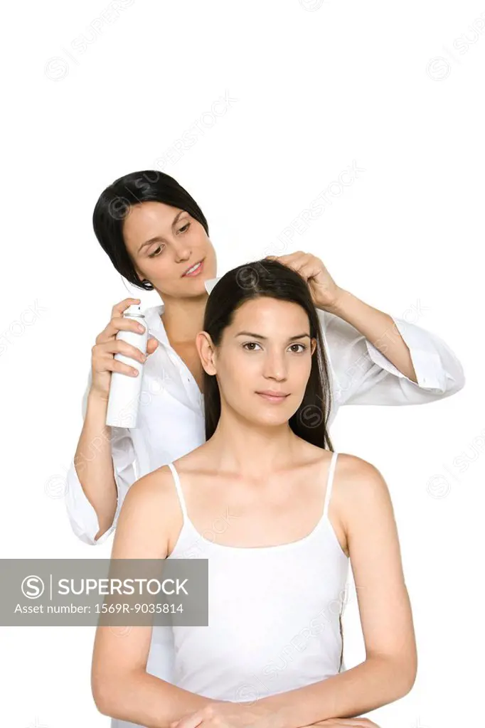 Woman having her hair styled, smiling at camera