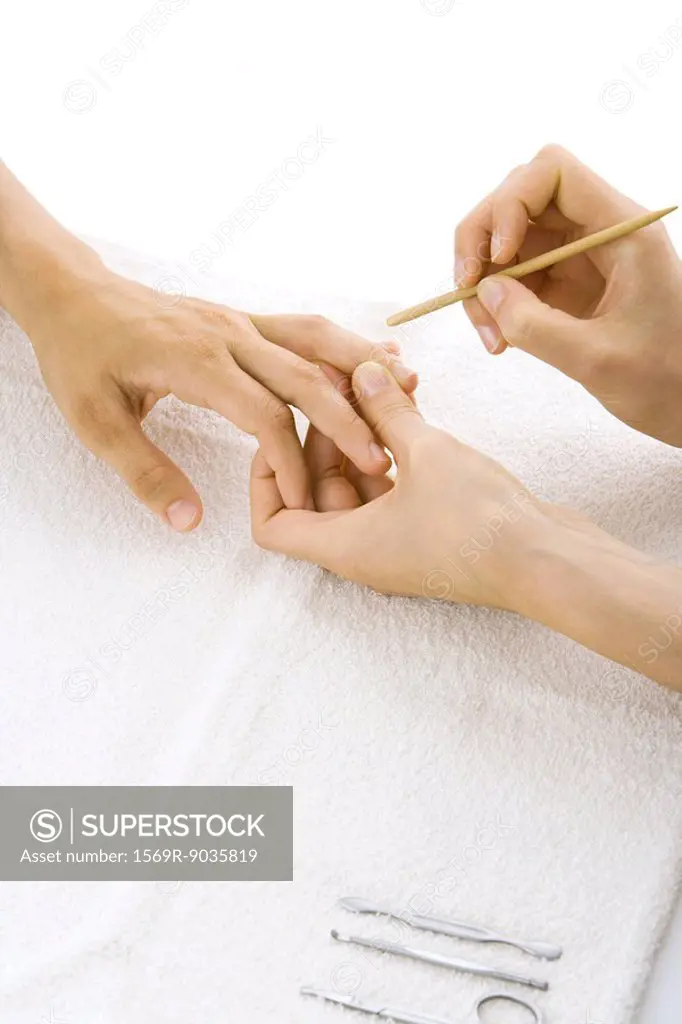 Person receiving manicure, cropped view of hands