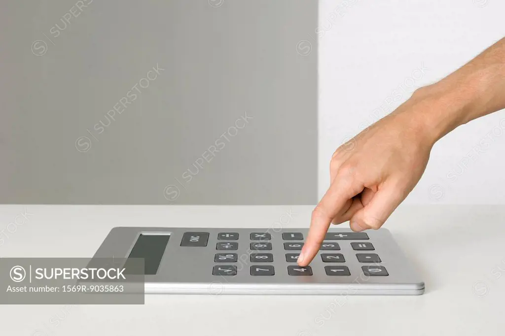Hand using oversized calculator