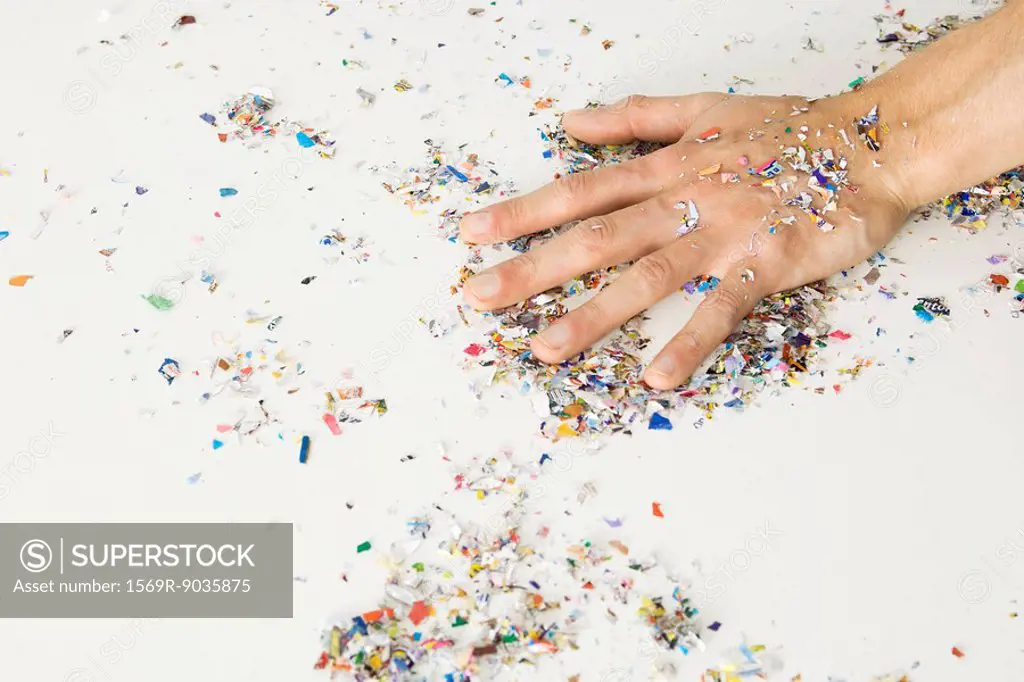 Hand covered with confetti