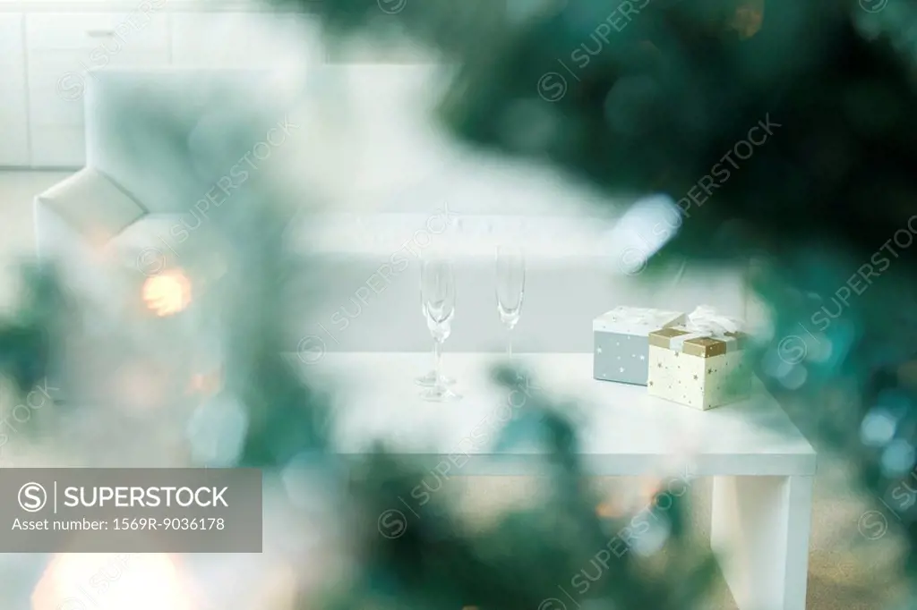 Champagne and gifts on coffee table, selective focus