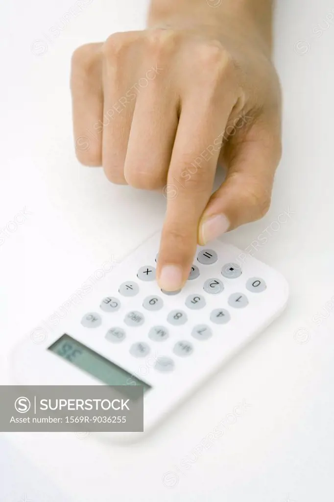 Person using calculator, cropped view of hand