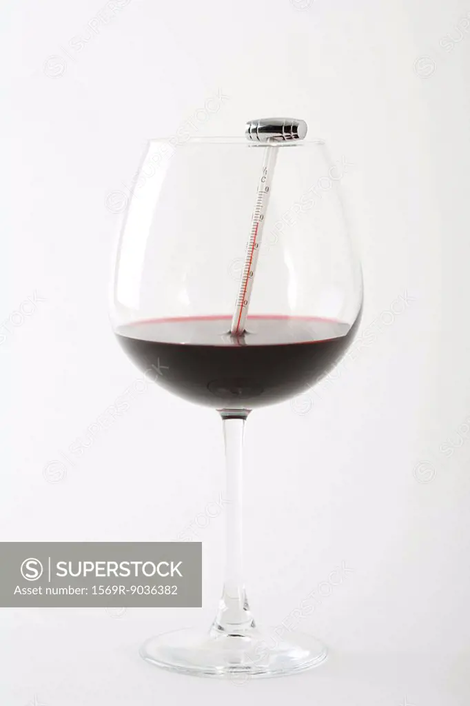 Thermometer in glass of red wine