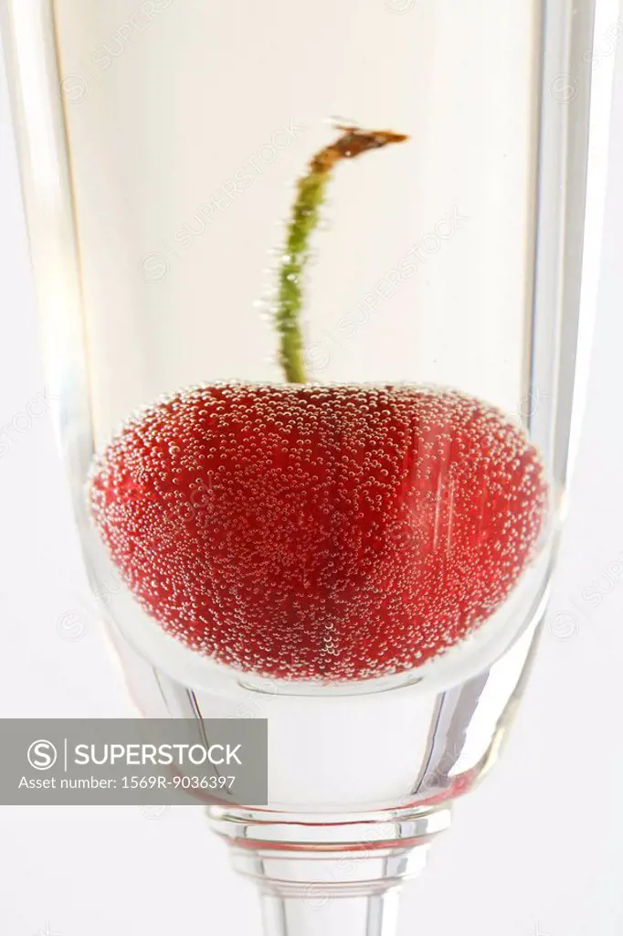 Cherry in glass of champagne, close-up