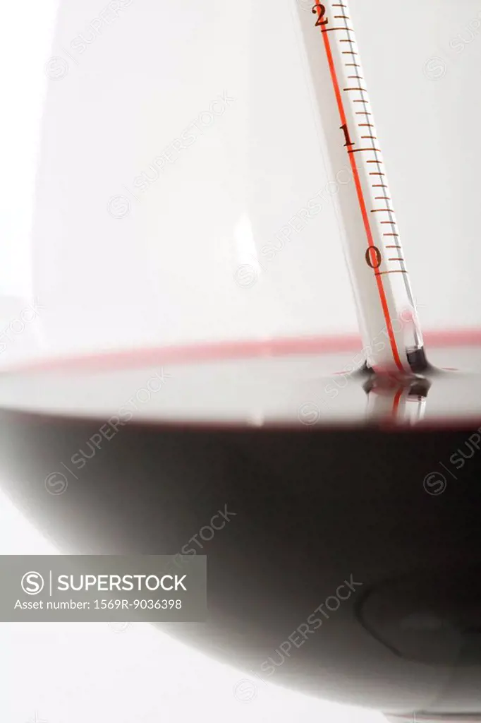 Thermometer in glass of red wine, extreme close-up