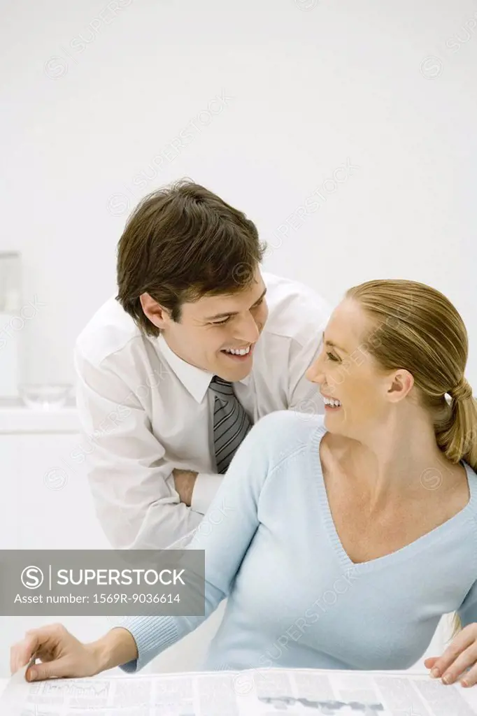Couple smiling at each other, woman looking back over her shoulder
