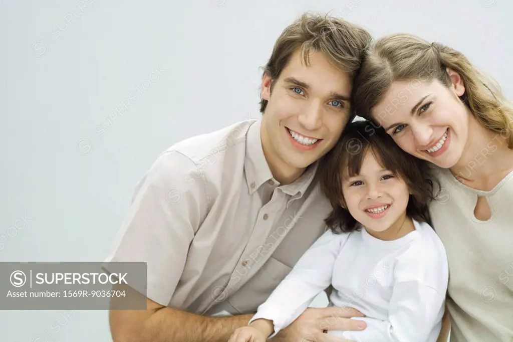 Young parents with little boy, smiling at camera, portrait