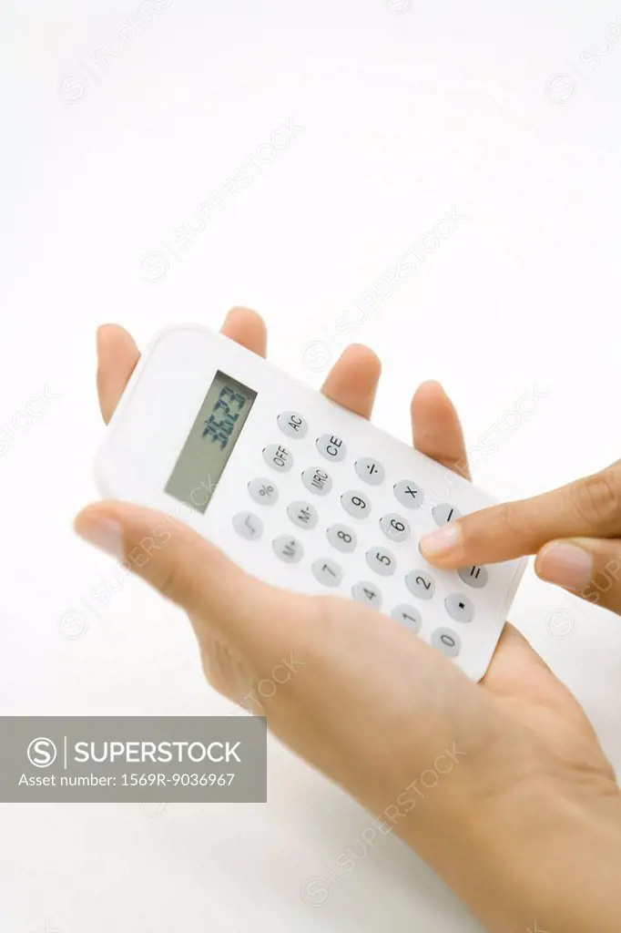 Person using calculator, cropped view of hands