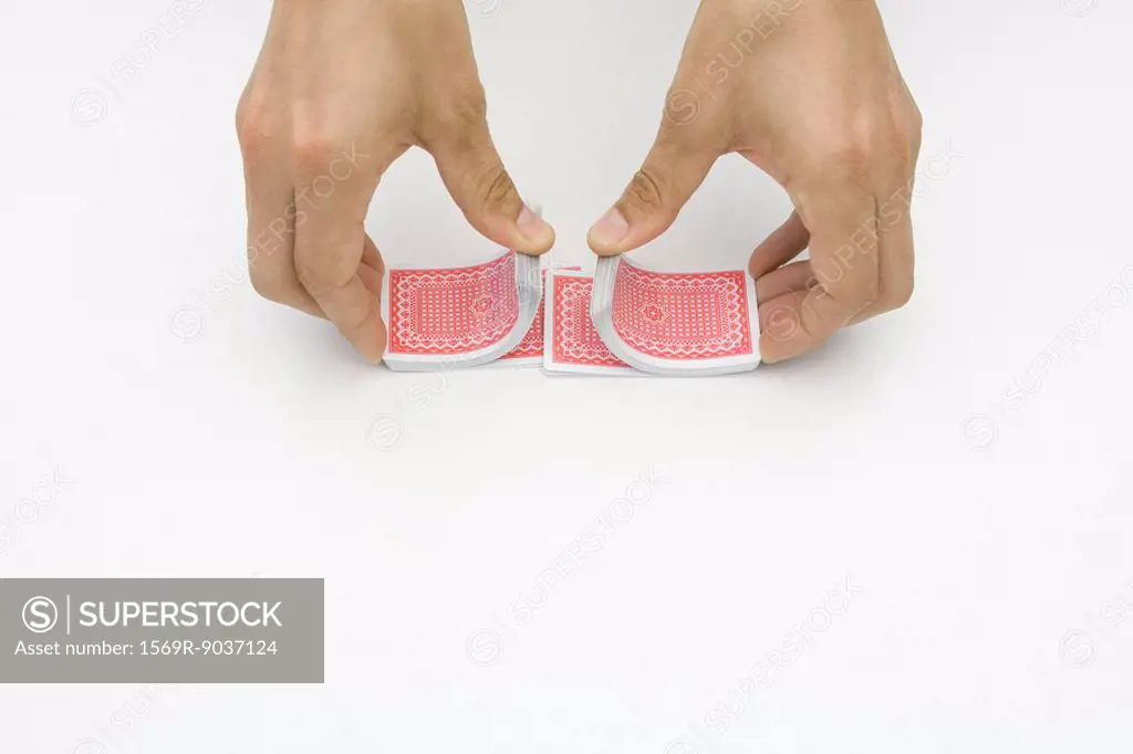 Pair of hands shuffling cards, cropped view