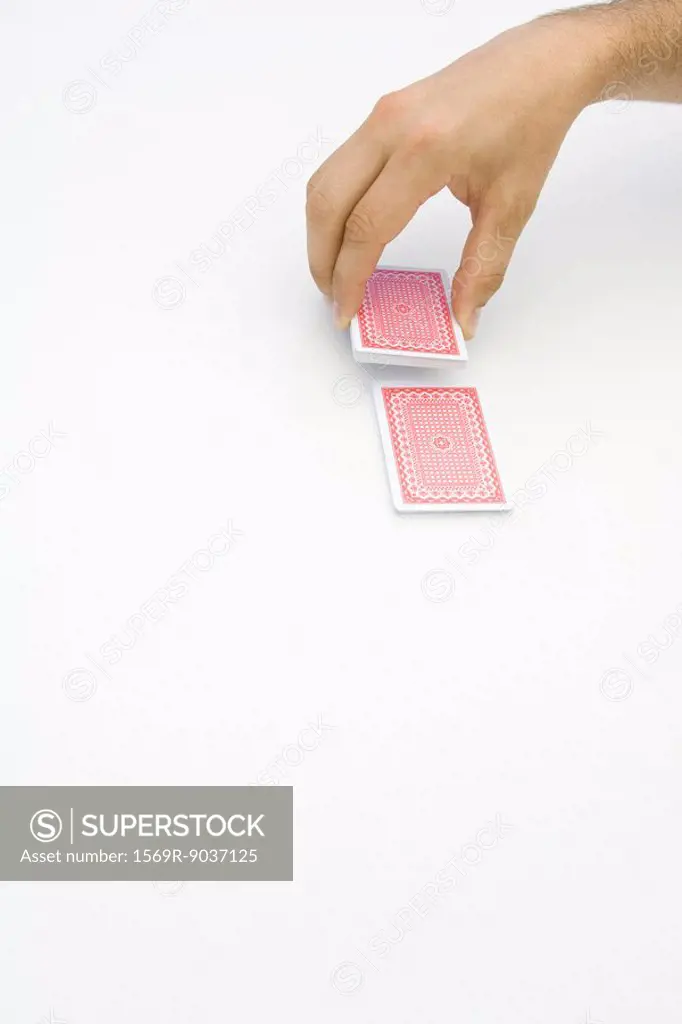 Hand cutting a deck of cards, cropped view