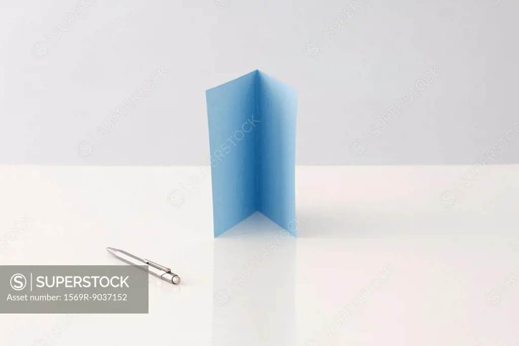 Greeting card standing upright, pen lying nearby