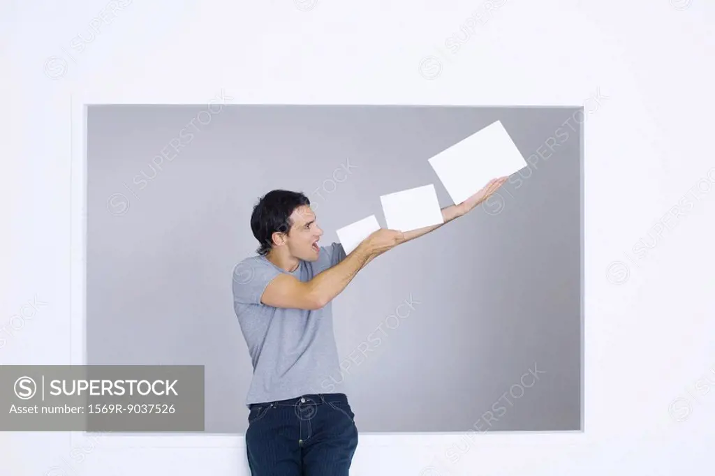 Man holding up blank papers, shouting