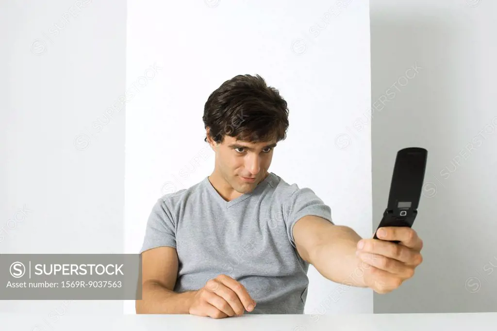 Man photographing self with cell phone