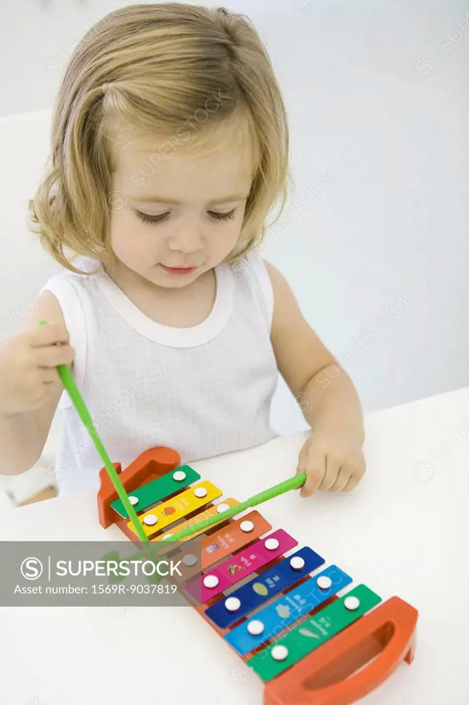 Toddler girl playing xylophone, high angle view