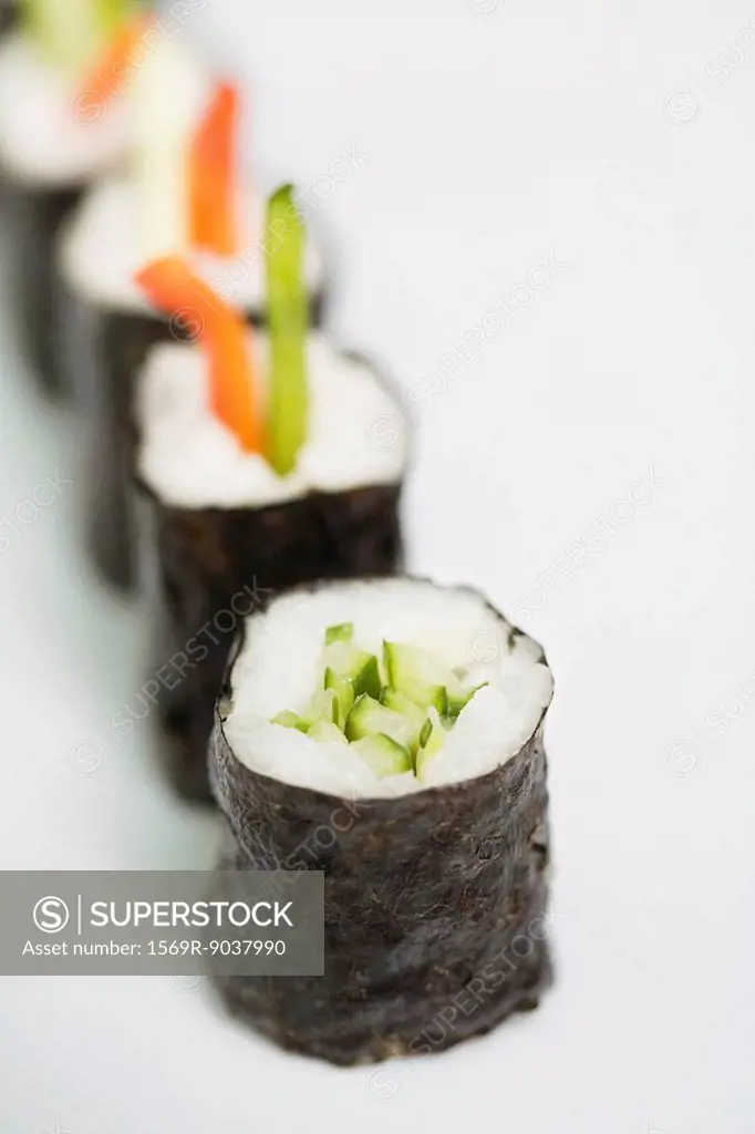 Row of maki sushi, close-up, focus on foreground
