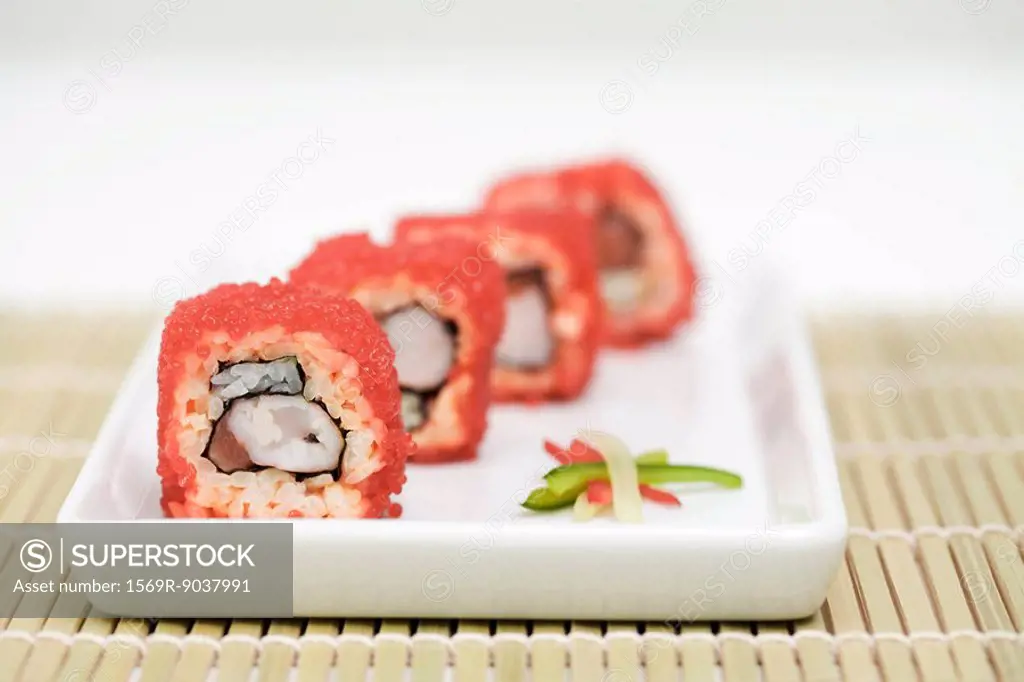Maki sushi rolled in red flying fish roe, cross section view